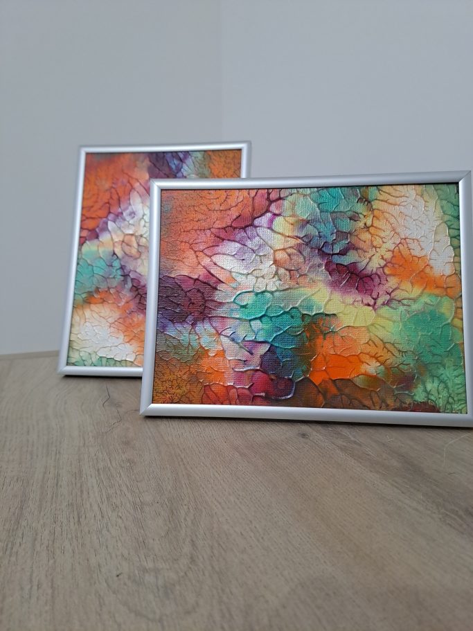 "Terre et lumière " Deux tableaux encadrés avec des motifs colorés en orange, turquoise et violet.